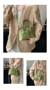 Detail view of the grass green leather mini handbag with stylish metal buckle and strap