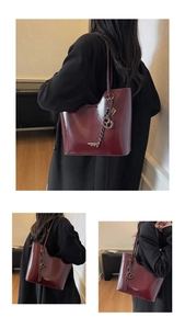 Detail view of burgundy wax leather bucket bag featuring unique asymmetrical top edge design