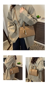 Close-up of brown herringbone woven handbag with elegant beaded metal ring charm