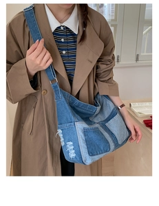 Detailed side view of denim tote bag showing patchwork fabric and distressed fringe edges