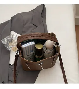 Interior view of brown lychee leather bucket bag showing capacity for daily essentials