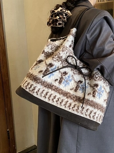 Retro plush tote bag with geometric pattern and faux suede base shown on a model