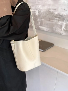 Elegant cream lychee pattern leather bucket bag with adjustable gold hardware strap