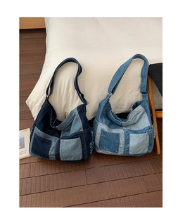 Detail of vintage denim patchwork tote bag featuring frayed edges and two exterior pockets