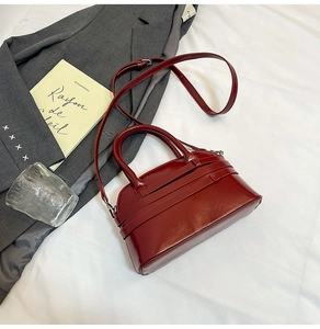 Detailed view of the red glossy leather mini square bag on a chic lifestyle background