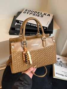 Caramel brown woven handbag with round handle and beaded charm for commuting
