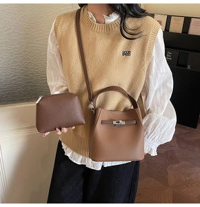 Detail of a brown lychee pattern leather bucket bag with a matching small coin purse