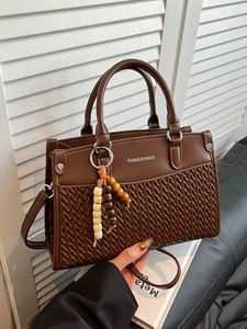 Brown faux leather handbag with herringbone weave and beaded charm accessory