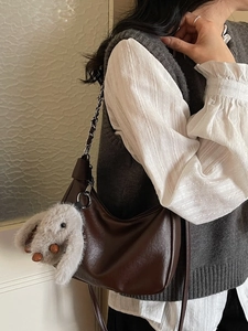 Brown vintage leather hobo bag with chain strap and cute plush rabbit charm