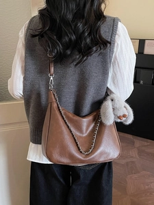 Brown semi-circle leather crossbody bag with silver chain and plush rabbit charm