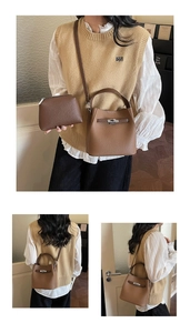 Detail of brown lychee leather bucket bag with silver metal swivel lock and strap