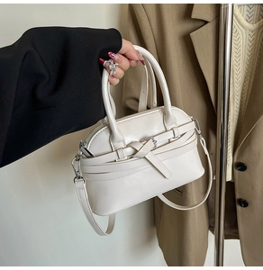 Detail of off-white crossbody bag with leather knot and sleek handle design