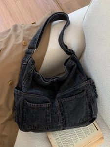 Large capacity washed denim tote bag with dual front pockets and wide shoulder strap