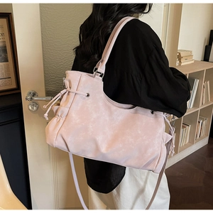 Lifestyle shot of large soft pink tote bag with drawstring details and side pockets