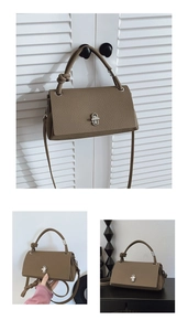 Detail of tan pebble leather crossbody bag showing twist handle and silver metal turn-lock