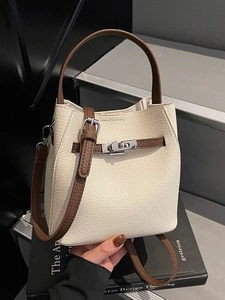 Vintage cream white bucket bag with brown handles and silver metal twist lock detail