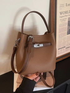 Brown lychee leather bucket bag with top handle and silver twist lock in vintage style