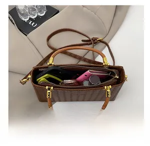 Top view of the brown woven tote interior showing spacious storage for phone and wallet