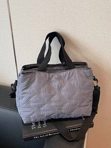 Sac fourre-tout gris matelassé avec broderie de nœuds blancs et bandoulière noire