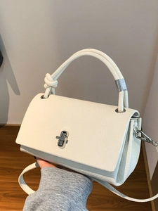 Minimalist white textured leather crossbody bag with silver twist lock and slim shoulder strap