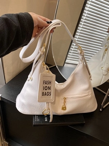 Minimalist white leather underarm bag with gold zipper and adjustable shoulder strap