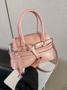 Pink glossy patent leather square handbag with decorative buckle and crossbody strap