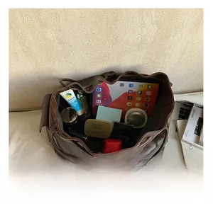 Top view of spacious brown drawstring bucket bag showing interior storage capacity