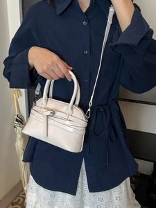 Elegant cream shell-shaped handbag with adjustable shoulder strap for women