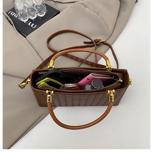 Detailed view of brown woven handbag showing interior storage capacity for daily essentials
