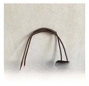 Detail of soft double handles with padded leather wraps on a dark brown tote bag