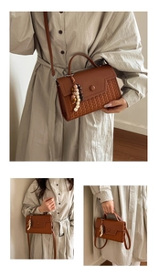 Detail of retro brown crossbody bag featuring woven texture and wooden bead handle charm