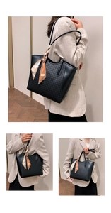 Detail view of black woven tote bag with smooth leather handles and fashion silk scarf