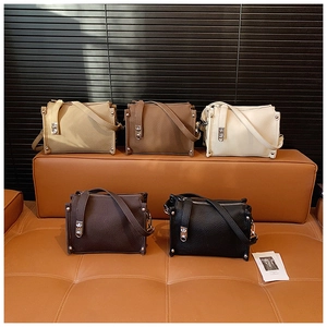 Detail shot of multi-color crossbody bags with lychee grain leather and silver rivets