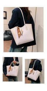 Detail showing high-capacity tote bag with purple embossed leather and printed silk scarf