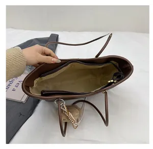 Spacious interior of brown tote bag featuring beige lining and zipper pocket