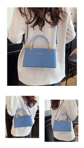 Detail of blue woven pattern handbag showing fine chevron texture and top handles