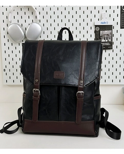 Detail of vintage PU leather backpack with magnetic buckle straps and FUIERMA logo