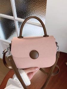 Chic pink handbag with brown leather strap for women, elegant crossbody style