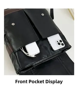 Detailed view of dual front pockets on brown PU leather backpack for phones and power banks