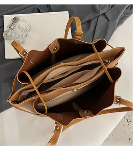 Detailed interior of brown tote bag showing multiple zipper compartments and storage slots