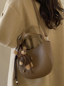 Brown litchi texture PU hobo bucket bag with a cute bear charm for women