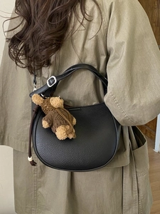 Chic black lychee grain PU half-moon bucket bag with cute bear charm and silver hardware