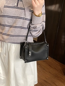 Minimalist black lychee leather shoulder bag with silver studs and metal lock detail