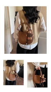 Detailed views of brown lychee leather bucket bag with cute teddy bear charm pendant