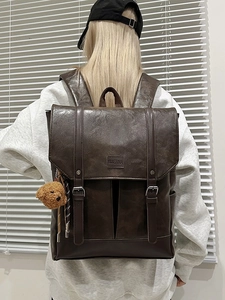 Vintage brown PU leather backpack with buckle straps and a cute teddy bear charm