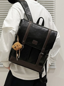 Japanese style black leather backpack with brown trim and cute teddy bear keychain