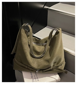 Detail of olive green large capacity tote bag with soft leather texture and stylish buckle