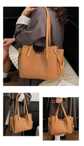Detail of caramel tote bag showing textured leather stitching and adjustable strap