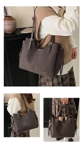 Detail of dark brown leather tote bag showing contrast stitching and drawstring design