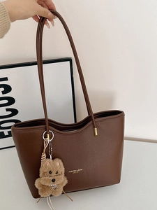 Retro dark brown pebbled leather tote bag with long straps and plush puppy charm